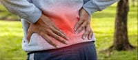 Why do women experience back pain more often than men?